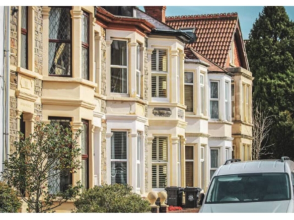 Victorian bay-windowed terraced houses on a sunny UK street