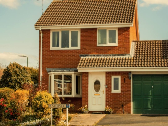 Charming British suburban detached home in warm sunlight